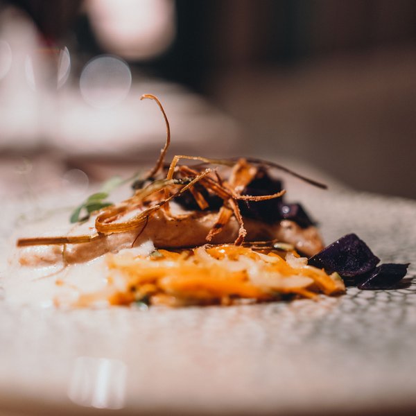 Sensoria Dolomites – Luxury for the Soul Gourmet dish with vegetables and sauce on patterned plate