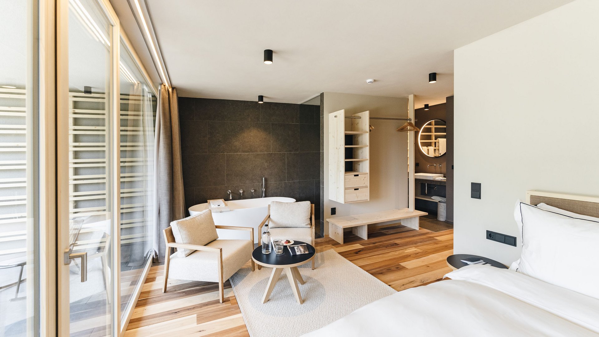 Sensoria Dolomites – Luxury for the Soul Modern hotel room with bathtub and seating area