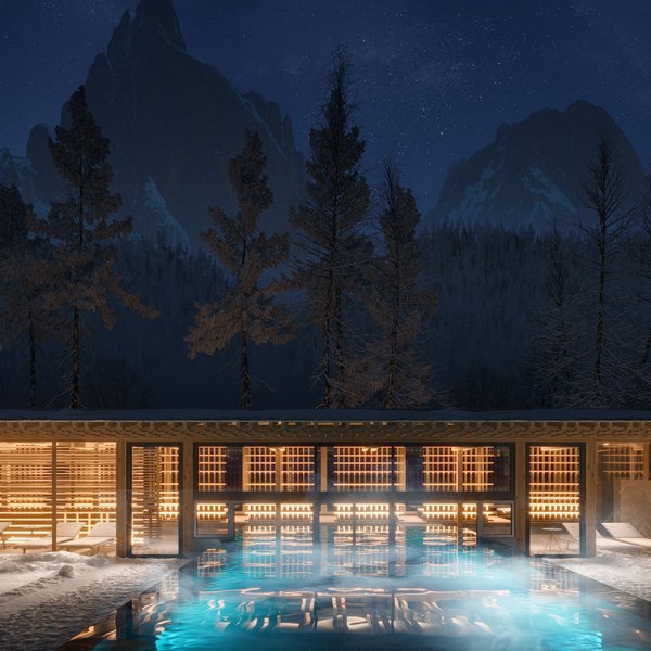 Sensoria Dolomites. Kraftort. Winterzauber. Beleuchteter Außenpool und Lounge bei Nacht mit Bergen im Hintergrund